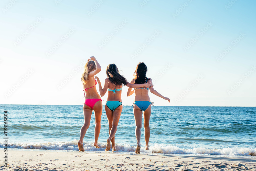 three girls having fun on beach, friends on beach in sunset light