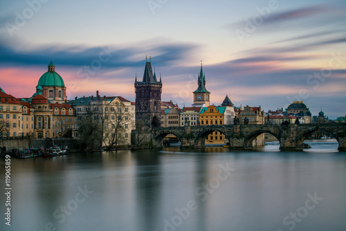 Amazing towers of Charles bridge and old town district with reflection at Vltava river during cloudy sunset, Prague, Czech republic © marekkijevsky