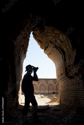 Adventurer photographer in the old destroyed mosque photo
