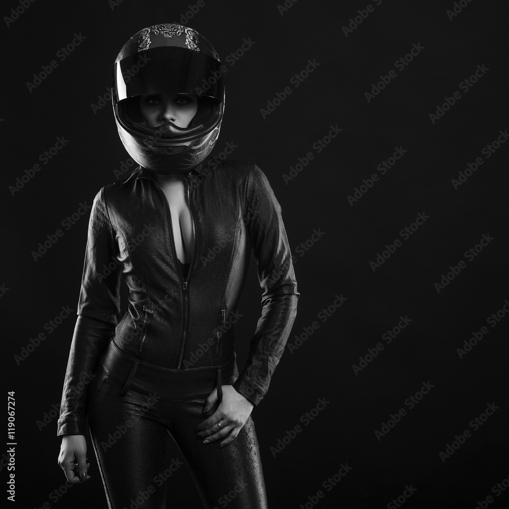  biker girl posing in studio in black background