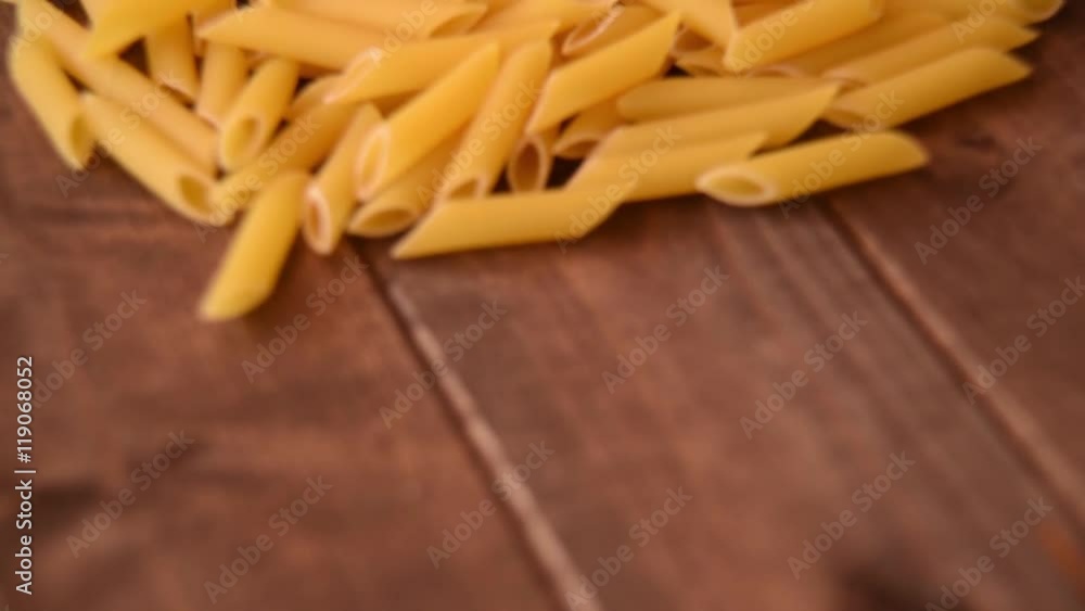 Raw pasta on a wooden background Raw pasta on a wooden background