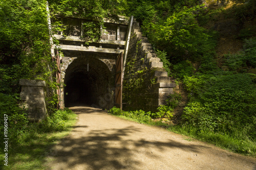 Fototapeta Naklejka Na Ścianę i Meble -  Bike Trail Tunnel / A bike trail passing through a former railroad tunnel.