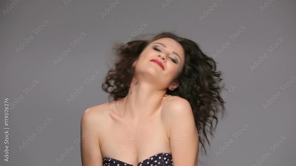 Young brunette with long brown curly hair dancing Young brunette with long brown curly hair dancing