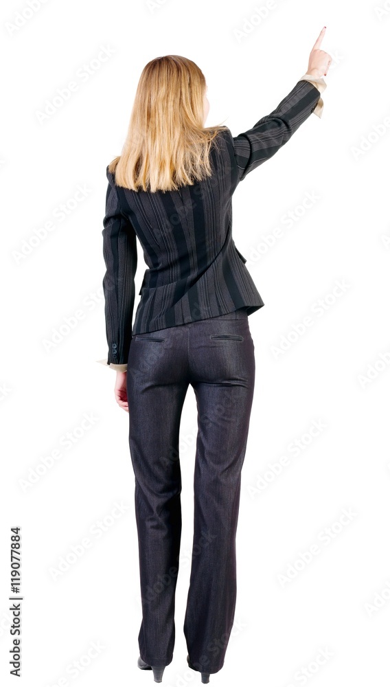Back view of young blonde business woman pointing at wall . beautiful girl in dark suit. Rear view people collection. backside view of person. Isolated over white background. Back view of young blonde business woman pointing at wall . beautiful girl in dark suit. Rear view people collection. backside view of person. Isolated over white background.