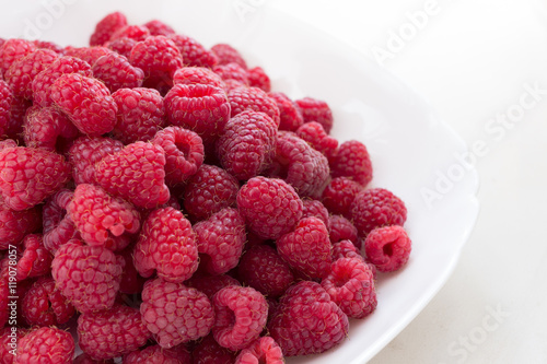 raspberries on a plate - side view
