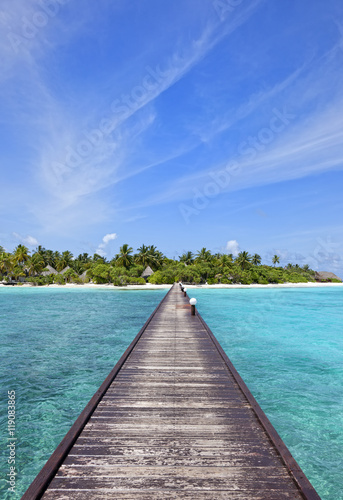 Bridge over blue ocean to paradise island