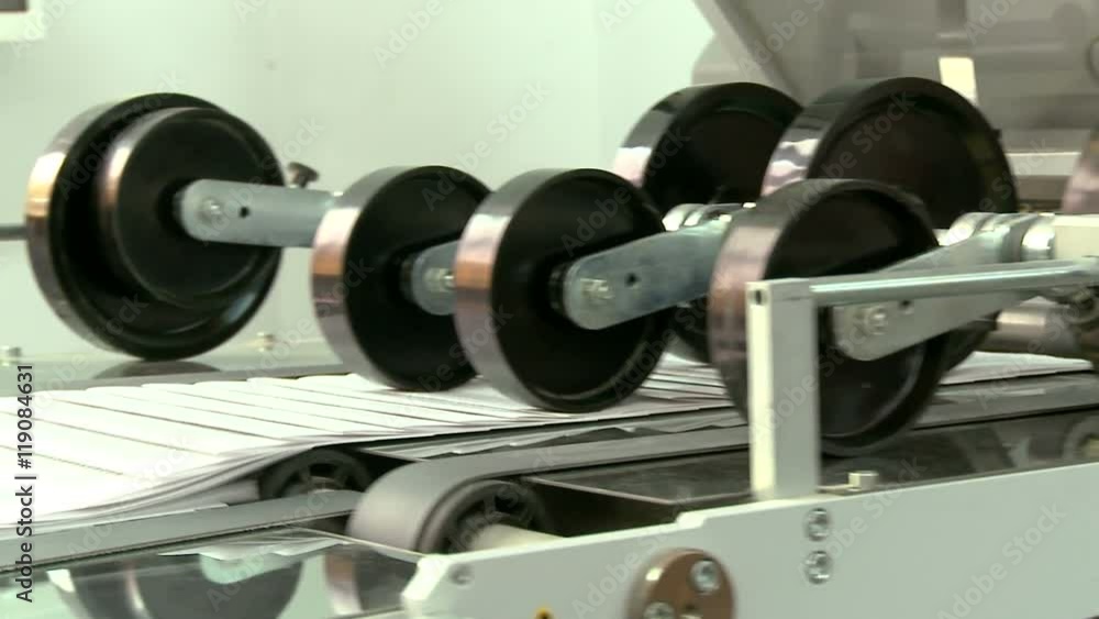 Printed sheets coming out of commercial printing press Printed sheets coming out of commercial printing press