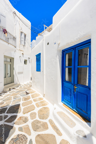 Blue door and windows of typical house on street of beautiful Mykonos town, Cyclades islands, Greece