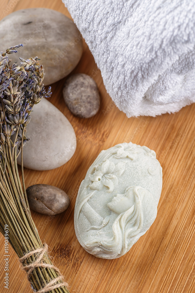 handmade ornamental soaps with lavender bunch and stones on wooden board, product of cosmetics or body care handmade ornamental soaps with lavender bunch and stones on wooden board, product of cosmetics or body care