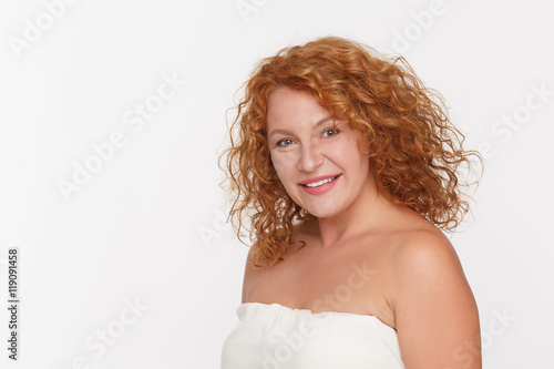 Portrait of smiling mature or middle aged woman looking at camera isolated on white background in studio. Emotions concept.