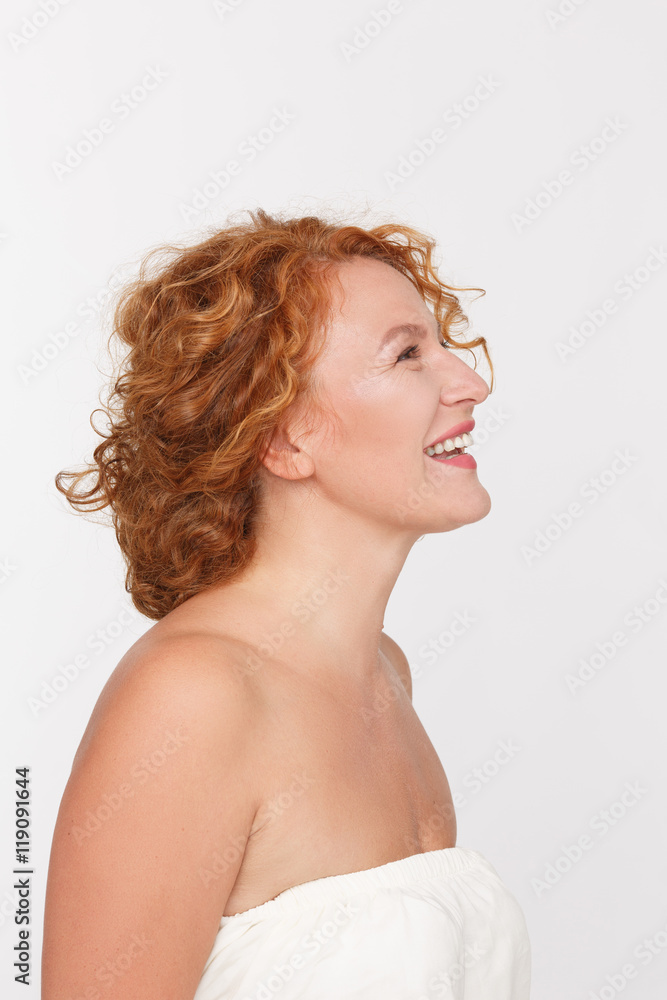 Picture of happy mature or middle aged woman looking away and thinking about something isolated on white background in studio. Picture of happy mature or middle aged woman looking away and thinking about something isolated on white background in studio.