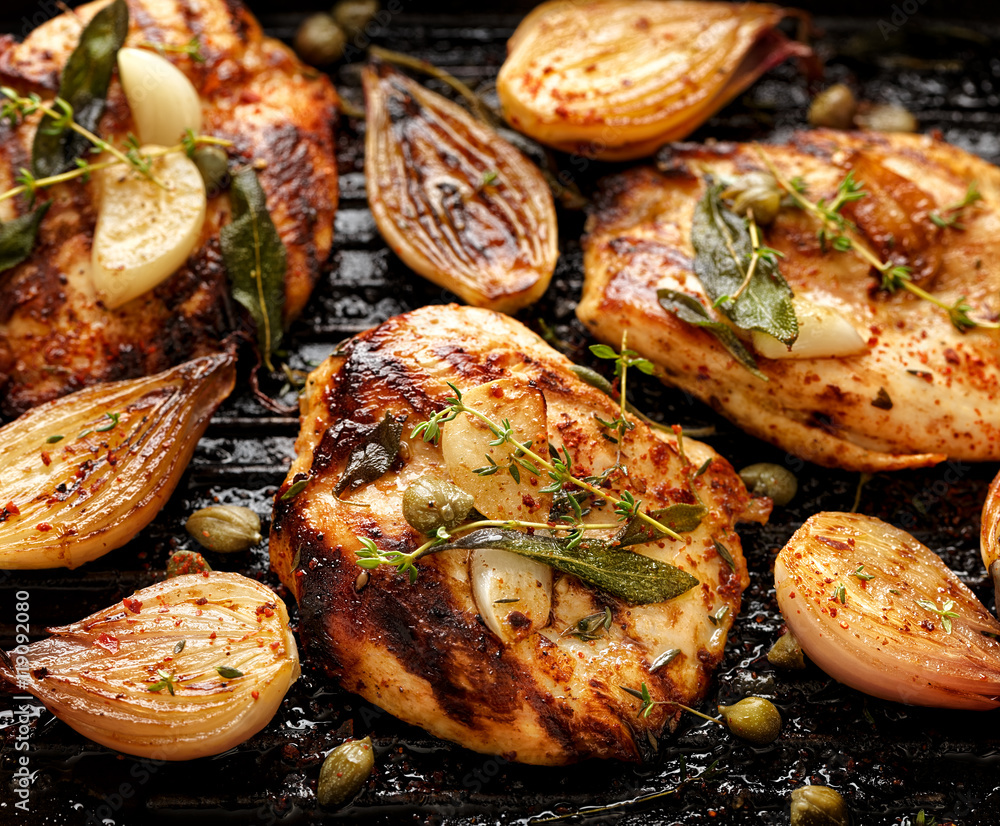 Grilled turkey fillet with addition of herbs, spices  and vegetables on the grill, top view 