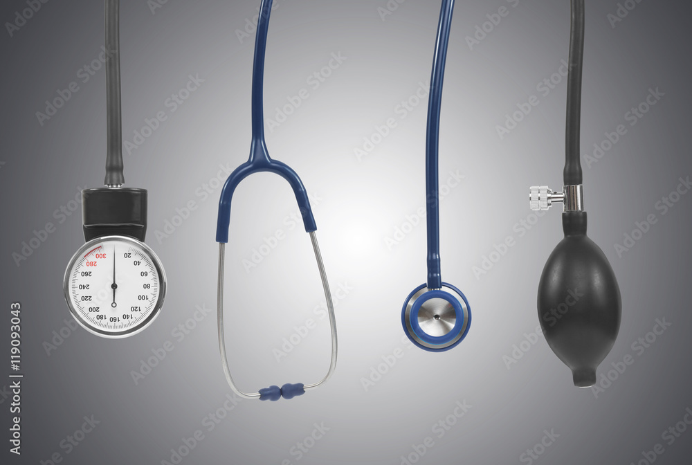 Blood pressure measuring instruments including stethoscope on grey background Blood pressure measuring instruments including stethoscope on grey background