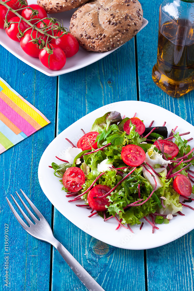 Fresh salad on a blue wooden table