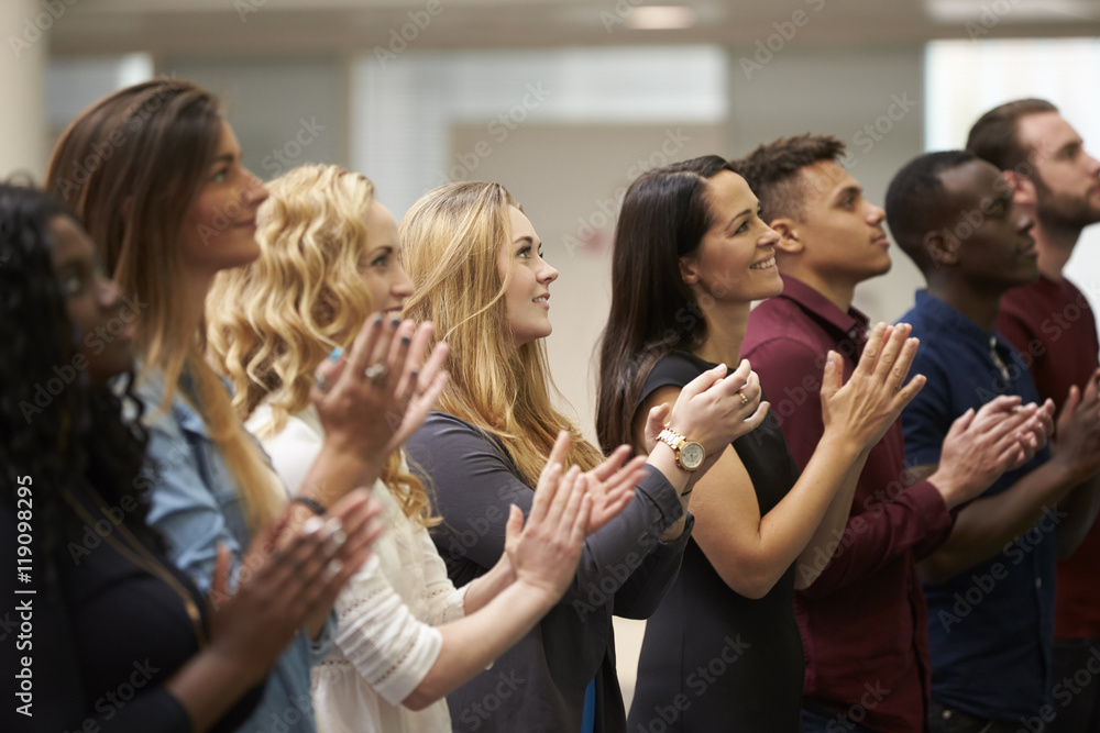 Adult students applauding at an event in their university Adult students applauding at an event in their university