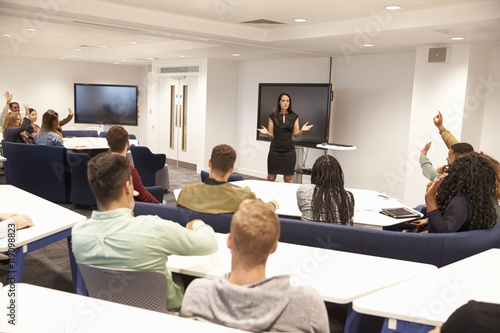 Photos University students study in classroom with female lecturer
