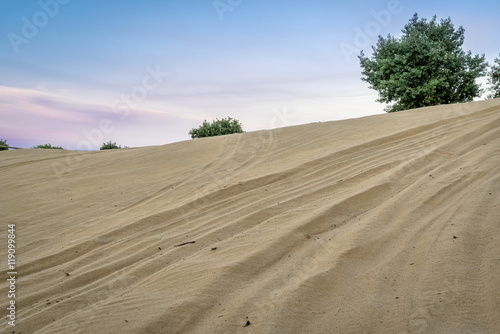 off road vehicle tracks on sand dune