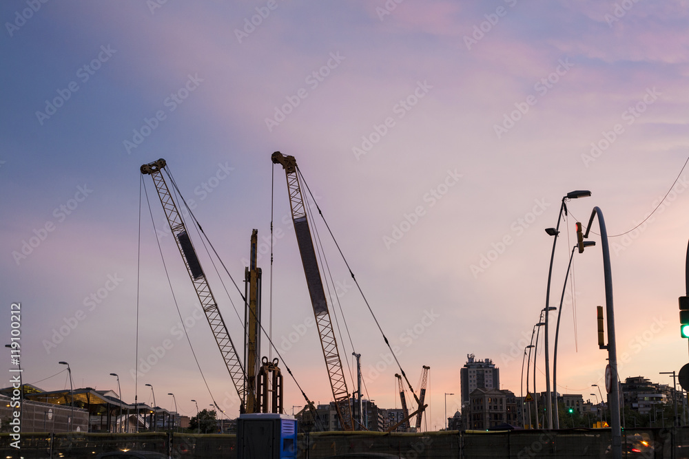 Fototapeta premium Construction cranes at sunset