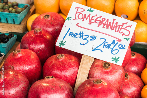 Pomegranates on Display with Handmade Sign with Name and Product in Farmers Market