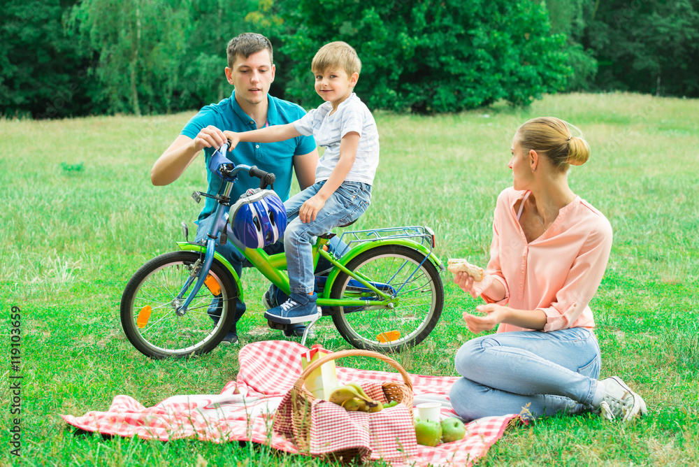 Boy With His Parents In The Park