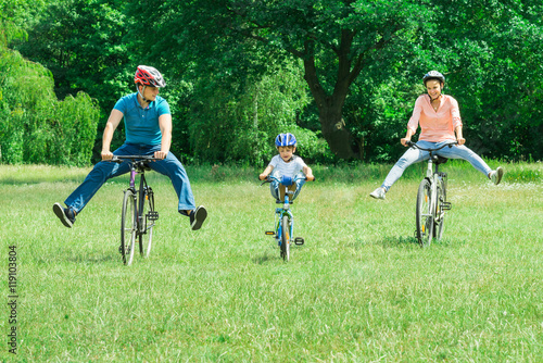 Family Enjoying The Ride On Bicycle At Park