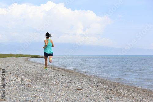 healthy young fitness woman trail runner running on seaside © lzf