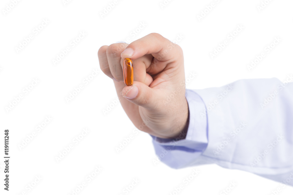 Doctor holding and showing one transparent pill of fish oil as lecithin for memory improve medicine Doctor holding and showing one transparent pill of fish oil as lecithin for memory improve medicine