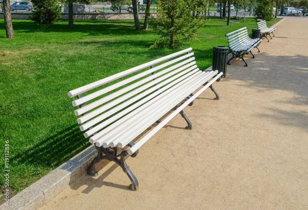 White bench in the park in the summer White bench in the park in the summer