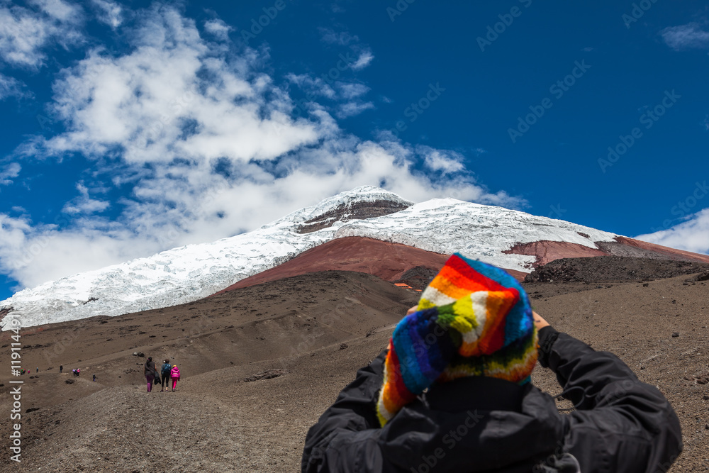 Cotopaxi volcano with some tourists ascending by its sandbanks