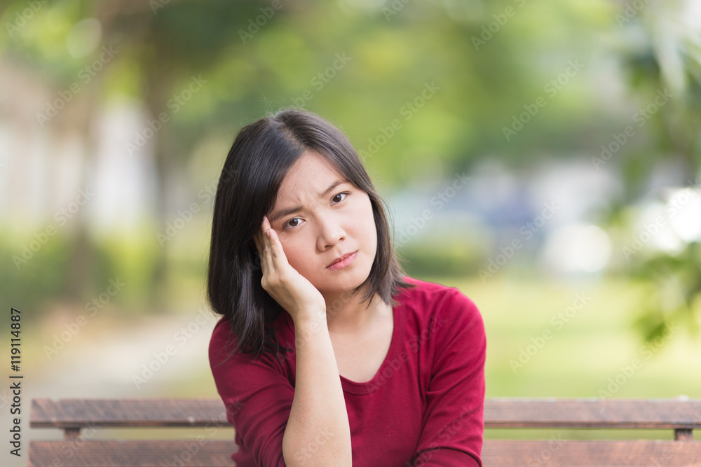 Woman Has Head Ache Sitting on Bench at Park Woman Has Head Ache Sitting on Bench at Park