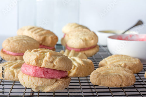 Close Up of Raspberry filled Melting Moments Biscuits on a Baking Tray with Selective Focus Horizontal