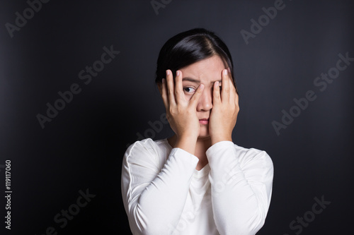 Woman hiding face laughing timid