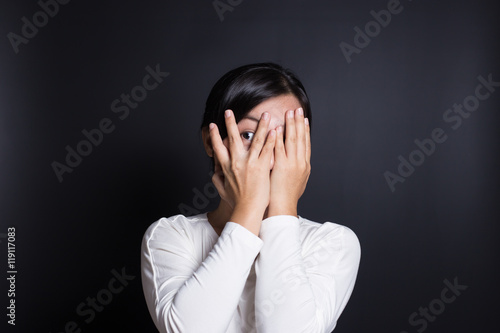 Woman hiding face laughing timid