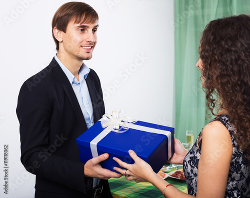 Woman giving present to man