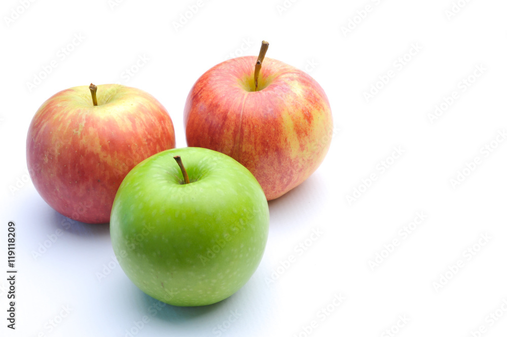 different concepts - green apple between red apples