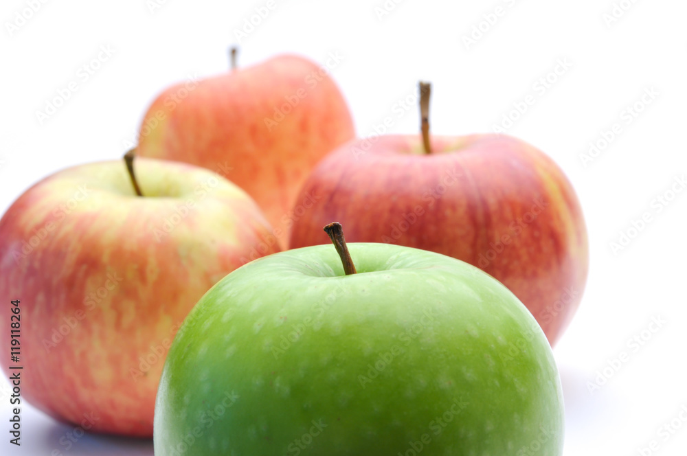different concepts - green apple between red apples different concepts - green apple between red apples