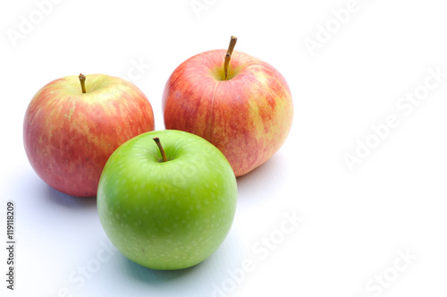 different concepts - green apple between red apples