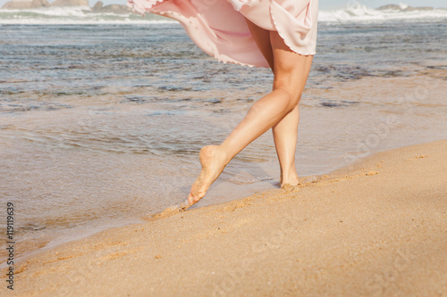 The young woman running on the beach