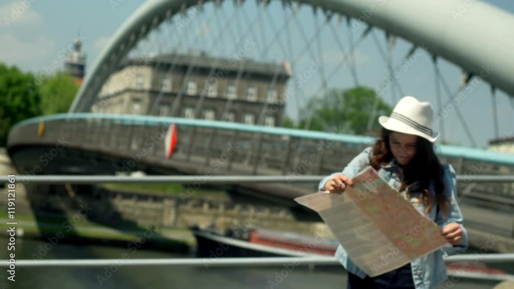 Pretty girl looking around the town and reading a map
Pretty girl looking around the town and reading a map