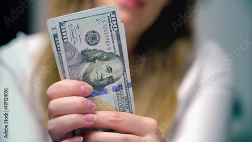 View of a woman Counting Many American 100 bills, Woman not happy about not having enough money