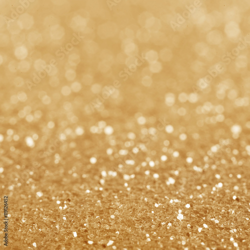 Gold defocused glitter background.