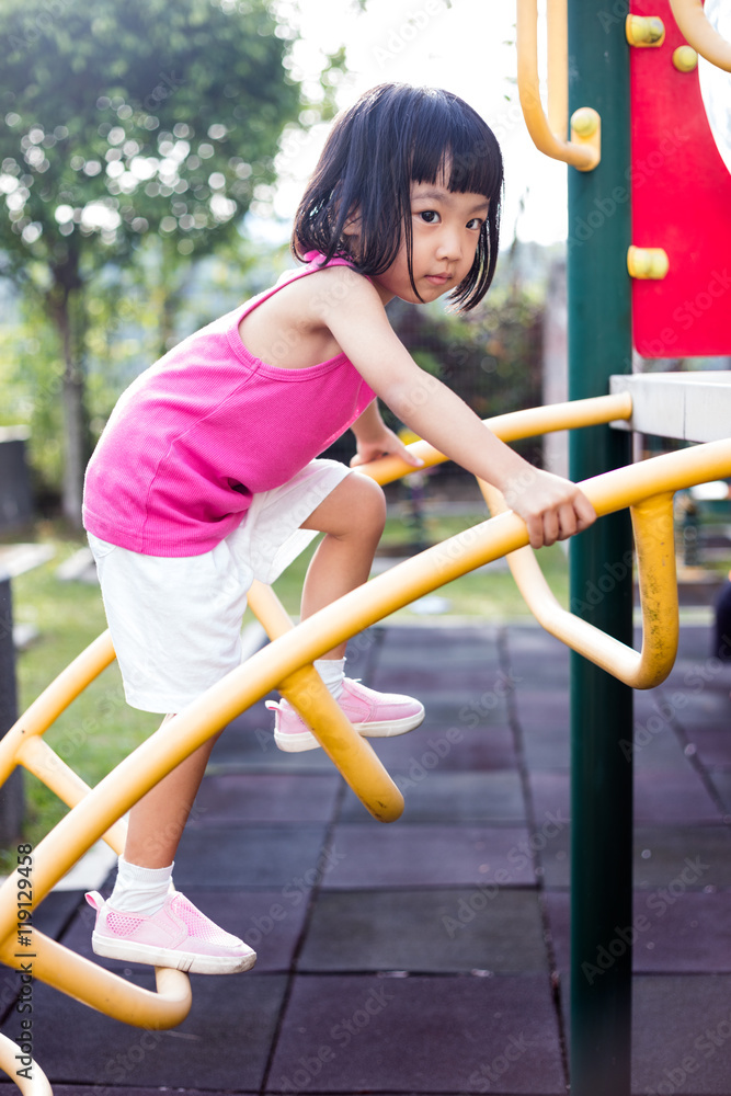 Fototapeta premium Asian Chinese little girl climbing at playground