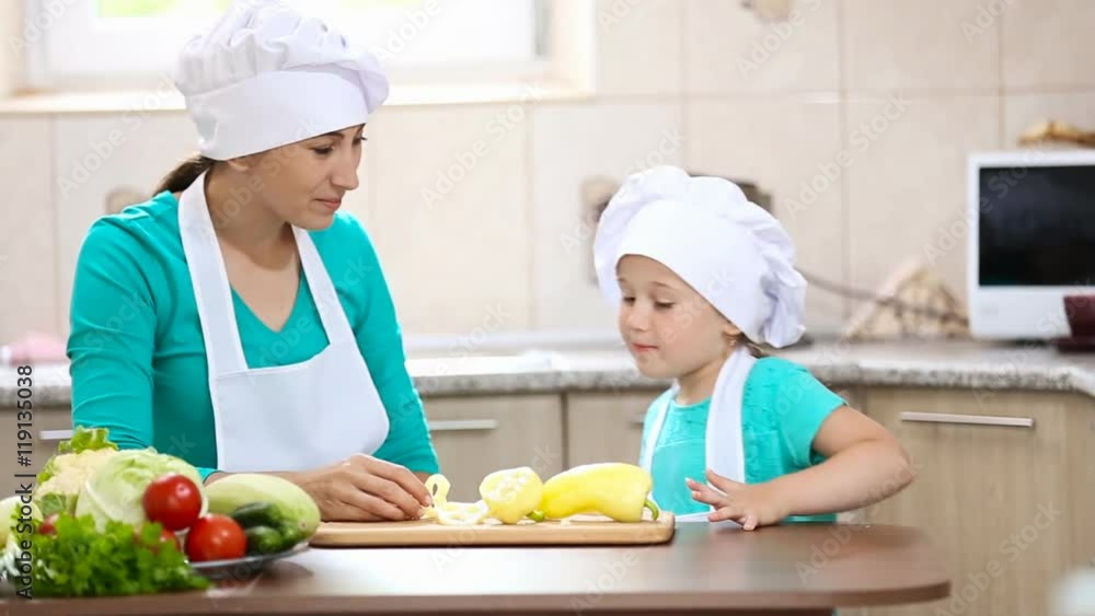 mother with her daughter cut pepper mother with her daughter cut pepper