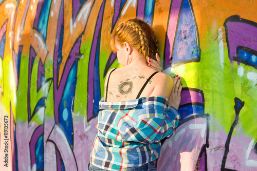 Girl on a background of graffiti photo