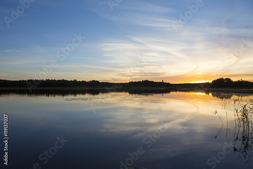Colorful evening by the lake in Finland. An image of a beautiful sunset on a summer night.