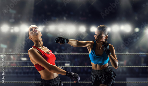 Girls boxing in ring . Mixed media