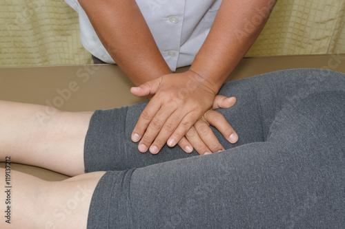 Physical therapist doing massage on woman's leg