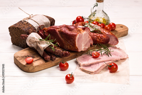 Antipasto catering platter with salami and meat on a wooden background