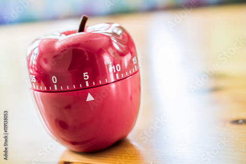 5 Minutes - Kitchen Egg Timer In Apple Shape On Wooden Table photo