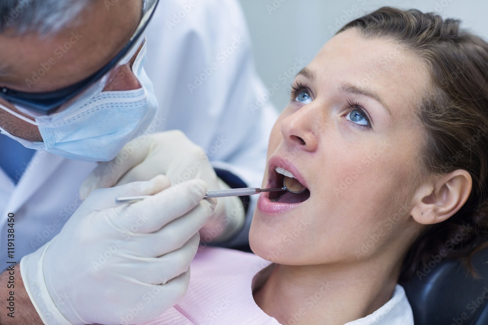 Patient teeth being examined with angle mirror Patient teeth being examined with angle mirror